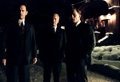 Mr. Rooney ( Paul Newman , center) tells Michael Sullivan ( Tom Hanks , left) and his son Connor Rooney ( Daniel Craig ) to take care of piece of business in Dreamworks' Road To Perdition