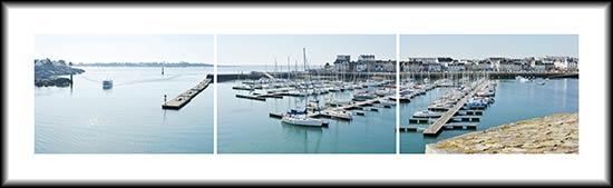 Un bateau de pêche entre au port de Concarneau devant le port de plaisance Un bateau de pêche entre au port de Concarneau devant le port de plaisance