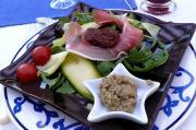 Salade composée avec des légumes, crudités, jambon cru et caviar d'augergine