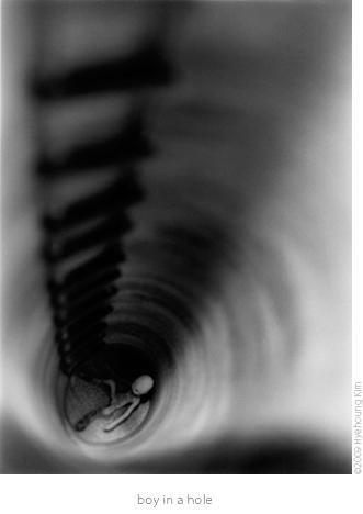 fighting fish studio black and white image boy in a hole ladder