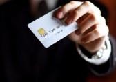 Business man presenting his credit card. Shallow DOF, focus on chip o card. Concept: Shopping and spending. stock photo