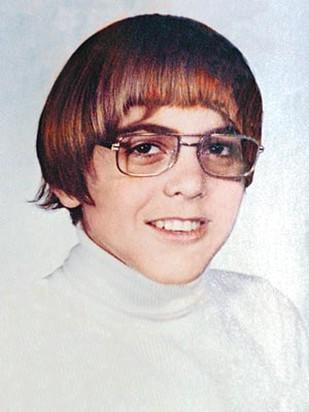 young George Clooney with a cool geek hairstyle