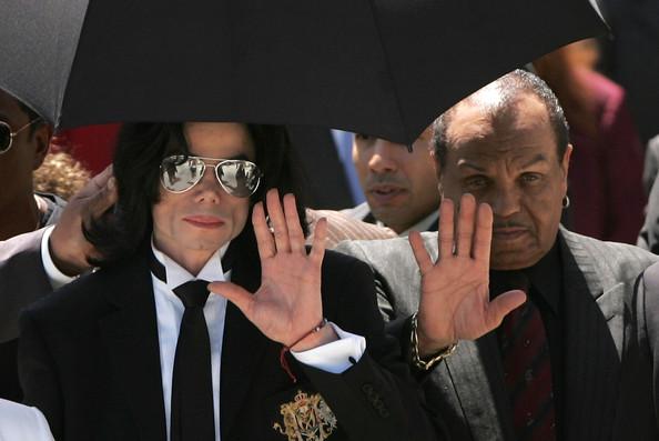 Michael Jackson and his father Joe Jackson (R) wave to fans as they exit the court after hearing the jury declare Not Guilty on all counts in the Michael Jackson child molestation trial at the Santa Barbara County Courthouse June 13, 2005 in Santa Maria, California. Jackson was charged in a 10-count indictment with molesting a boy, plying him with liquor and conspiring to commit child abduction, false imprisonment and extortion.