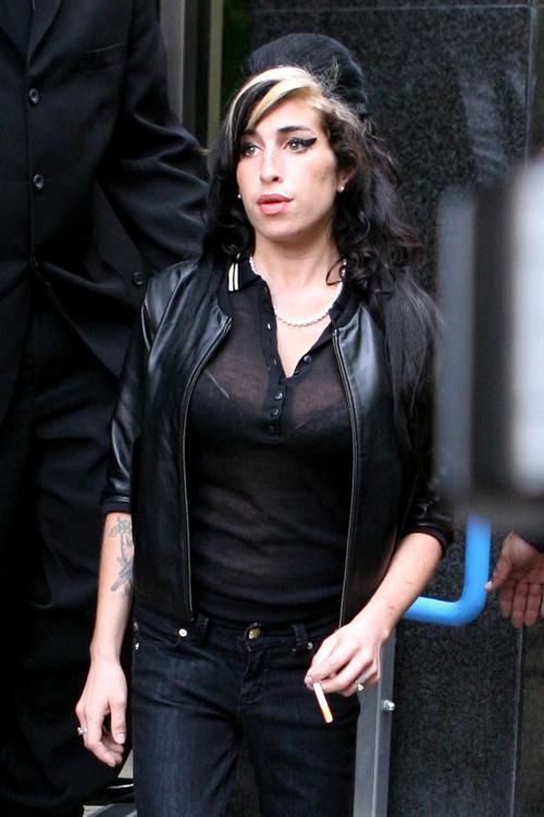 Amy Winehouse leaves a London court after being found 'not guilty' of assault