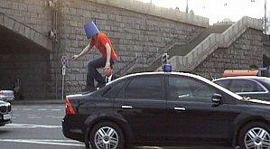 crazy_man_in_blue_pail_jumps_on_car_04.jpg