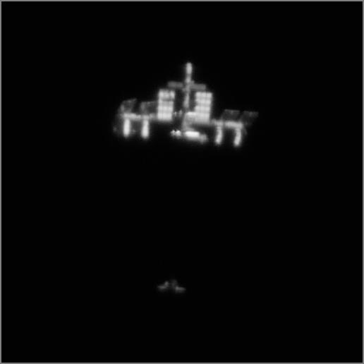 Discovery et ISS photographiées depuis la Terre par T. Legault