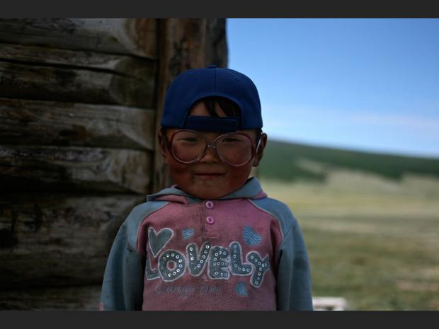 Le fils du chaman Nergoui est fier de poser avec les lunettes de son père, à Tsagaannuur, dans la province de Khövsgöl (Mongolie). Le fils du chaman Nergoui est fier de poser avec les lunettes de son père, à Tsagaannuur, dans la province de Khövsgöl (Mongolie).