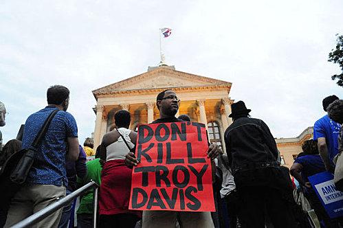 michel tabanou 778646 a-protester-holds-a-placard-during-a-rally-to-show-s