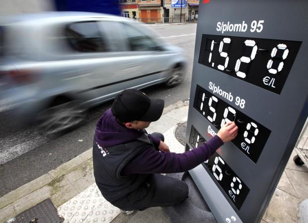 An petrol station employee changes petrol prices in Nice