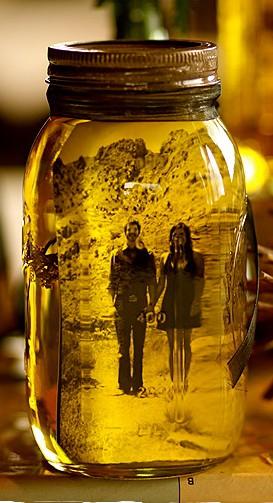 Put a picture in a jar of olive oil. The oil preserves the picture and gives it a sepia tone. Plus a totally unique way of displaying pictures.