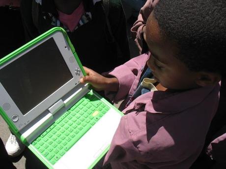 child going to school with his XO laptop