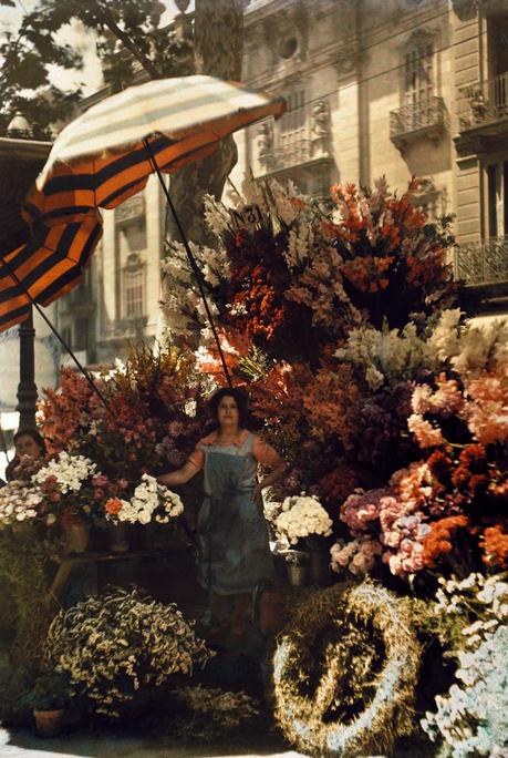 A woman stands in front of her flower stand on the Rambla in Barcelona, Spain, March 1929.Photograph by Jules Gervais Courtellemont, National Geographic