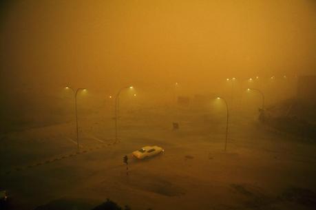 A combination sand and rain storm batters a lone automobile in Kuwait, May 1969.Photograph by David Cupp, National Geographic