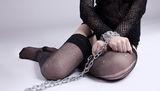 Girl sit with chain on hands - bdsm games Royalty Free Stock Images