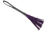 Purple leather fetish whip on white Royalty Free Stock Photography