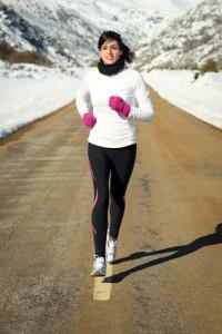 Woman running in winter on road