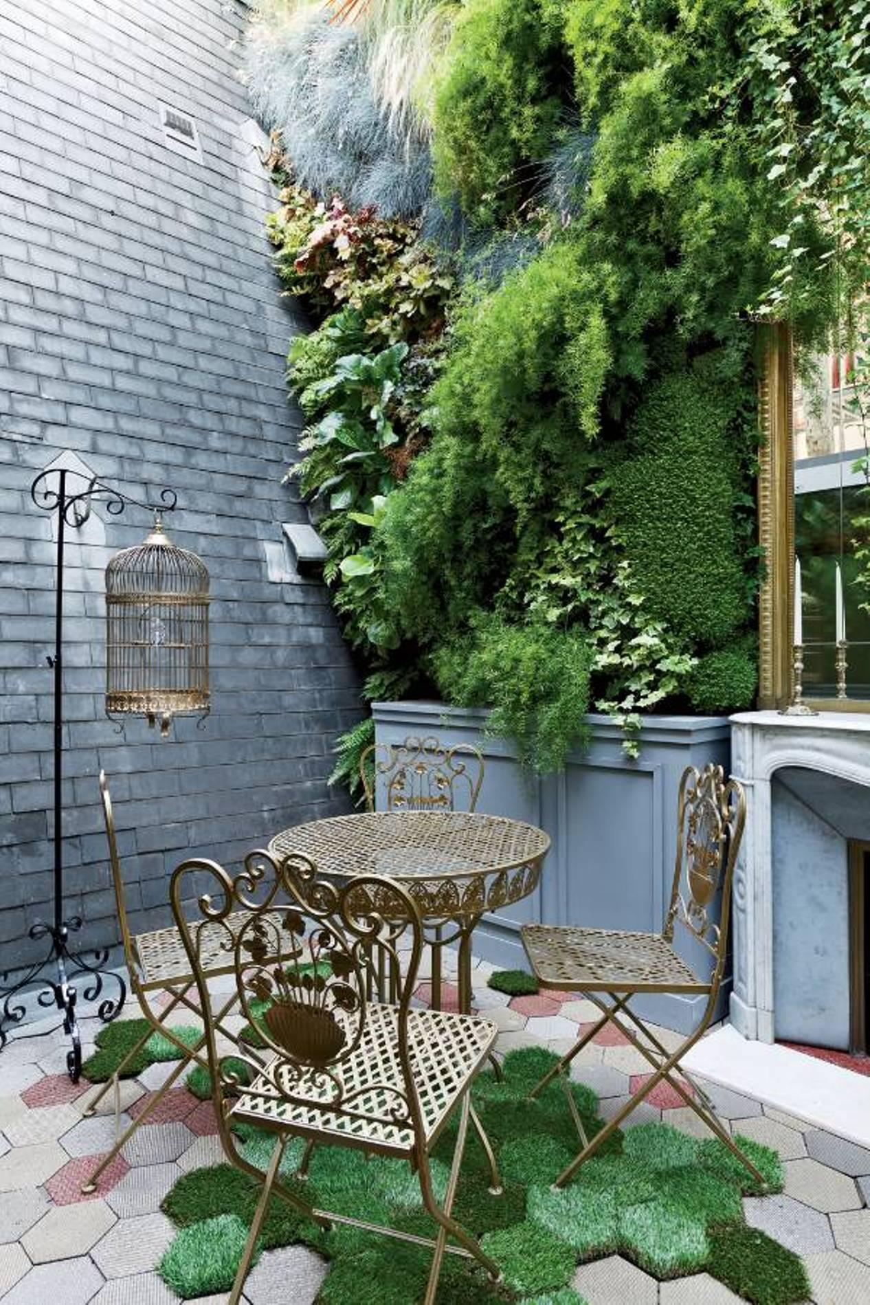small-patio-decor-with-vertical-plants-and-metal-furniture