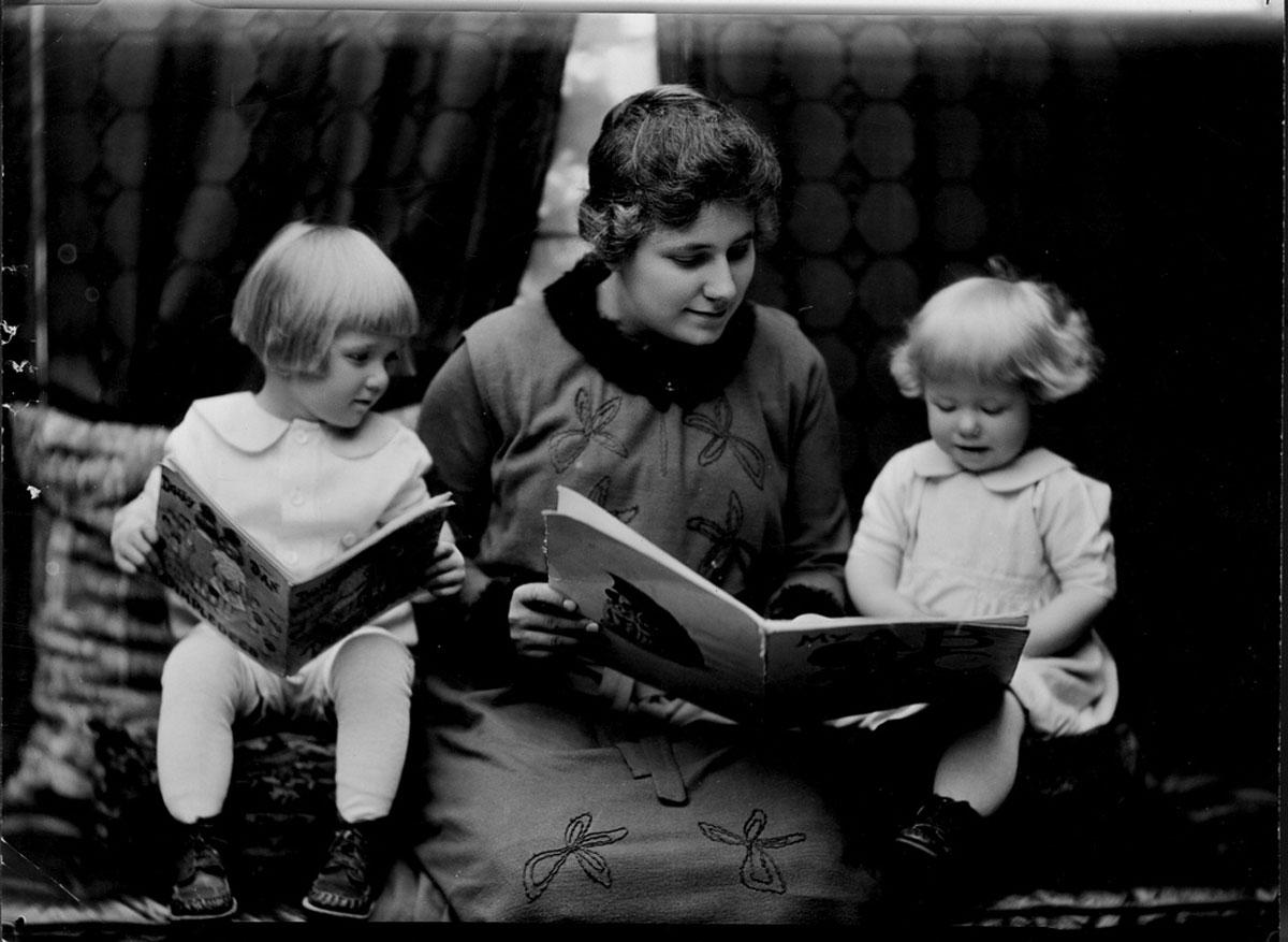 Student reading to two little girls. Photographed for 1920 home economics catalog by Troy, Cornell University Library