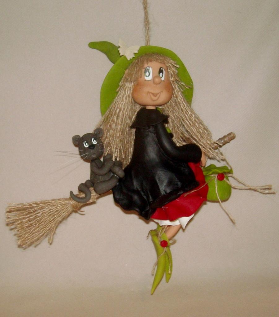 Sorcière avec son p'tit chat à suspendre en porcelaine froide Sorcière avec son p'tit chat à suspendre en porcelaine froide