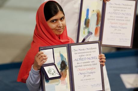 Nobel Peace Prize laureate Malala Yousafzai poses with the medal and the diploma during the Nobel Peace Prize awards ceremony at the City Hall in Oslo December 10, 2014. Pakistani teenager Malala Yousafzai, shot by the Taliban for refusing to quit school, and Indian activist Kailash Satyarthi received their Nobel Peace Prizes on Wednesday after two days of celebration honouring their work for children's rights. REUTERS/Suzanne Plunkett (NORWAY - Tags: SOCIETY TPX IMAGES OF THE DAY) - RTR4HFOP
