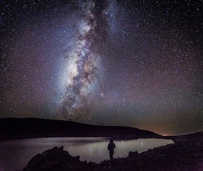 Photograph of the Milky Way and astronomer Brandon Carroll