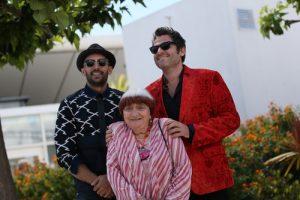 Matthieu Chedid (R), Agnes Varda and JR (L) attend the 'Faces, Places (Visages, Villages)' photocall during the 70th annual Cannes Festival at Palais des Festivals on May 19, 2017 in Cannes, France. / Shutterstock.com