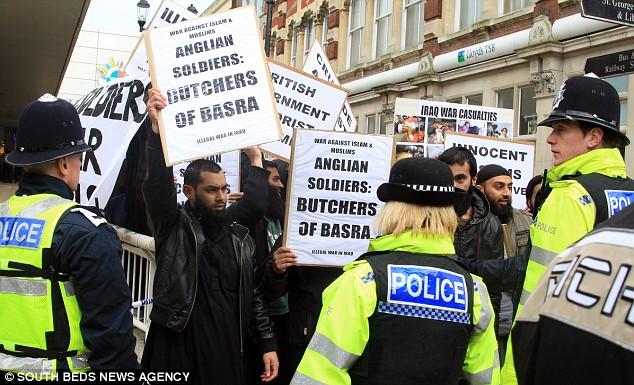 The Muslim extremists brandished banners calling British soldiers 'Butchers' during the homecoming on Tuesday