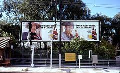 Beer advertisments in Afrikaans and English at a South African Railway Station