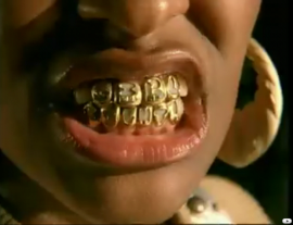 A ghetto chick wearing gloden teeth - Girlfight video by Brooke Valentine