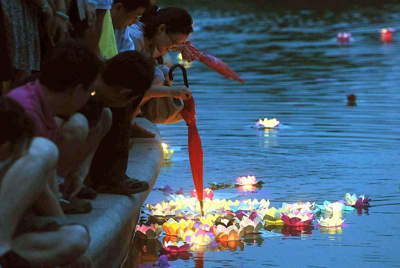 Mercredi 16 juin, ces familles chinoises déposent, sur un lac, des lanternes flottantes confectionnées avec des fleurs de lotus, pour marquer le début du festival de Duanwu, également connu sous le nom de Dragon Boat Festival. 