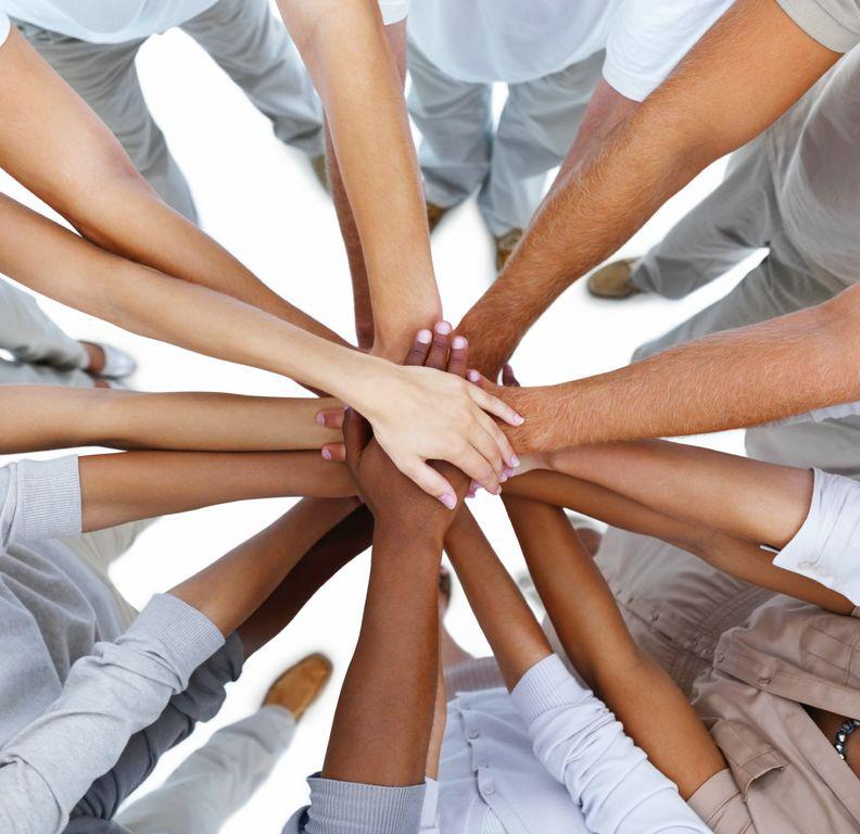 Business people standing with hands together