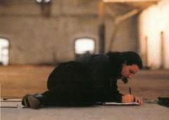 lying on warehouse floor, writing, close-up–'U2 Rattle & Hum - The official book of the U2 movie'–[home8.inet.tele.dk].jpg