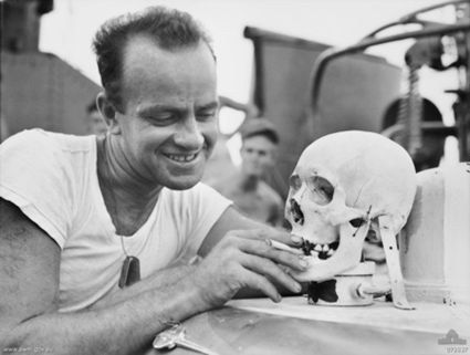 Lieutenant (junior grade) e. v. mcpherson, of columbus, ohio with a japanese skull which serves as a mascot aboard the united states navy motor torpedo boat 341