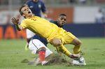 769074_romania-s-costin-lazar-is-fouled-by-france-s-yann-m-vila-during-their-euro-2012-group-d-qualifying-match-at-the-national-arena-stadium-in-bucharest