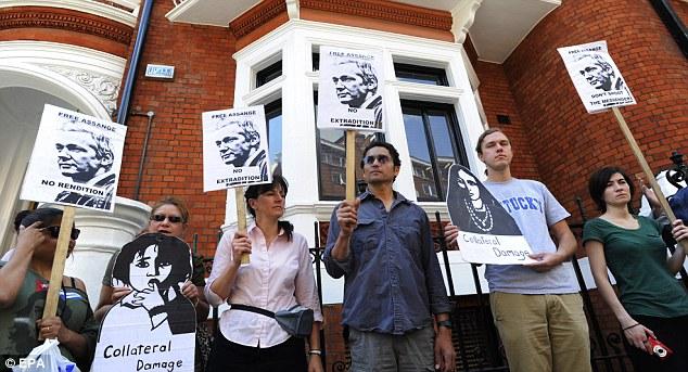 People show support outside the embassy for Assange, who faces charges of sexual assault
