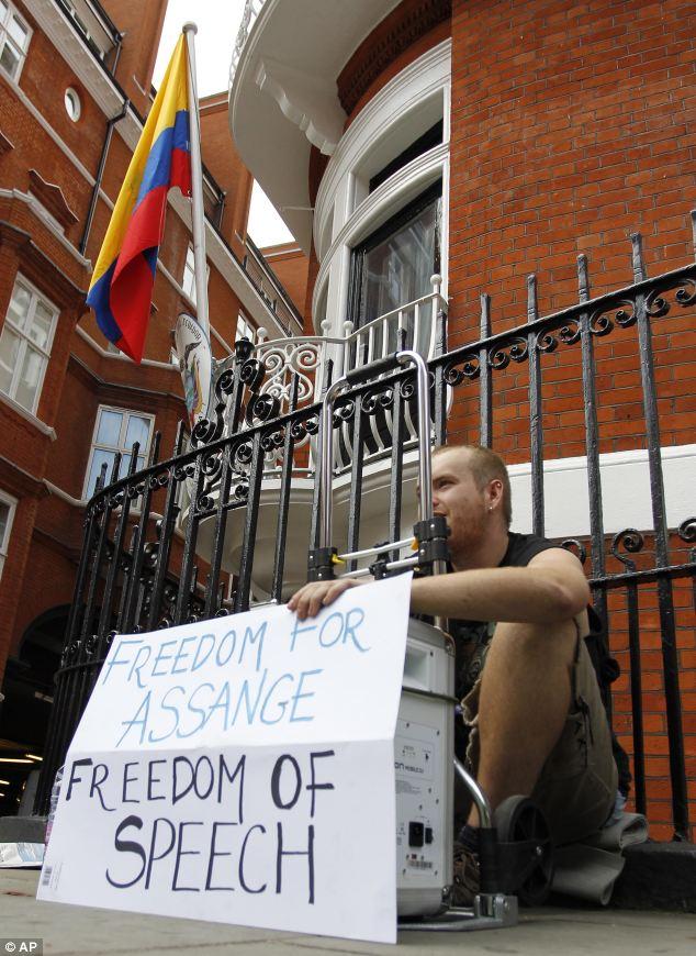 A supporter of WikiLeaks founder Julian Assange makes a statement outside the Ecuadorian Embassy in Knightsbridge