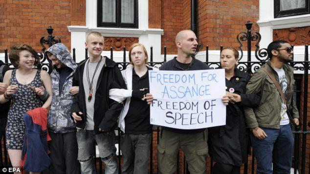 Supporters of Julian Assange link arms outside the Ecuador embassy where Wikileaks founder has sought political asylum 