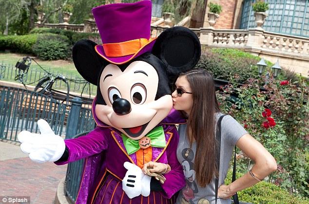Dressed for Halloween: Nina Dobrev kissed Mickey Mouse in front of The Haunted Mansion attraction at the Magic Kingdom park in Lake Buena Vista, Florida today