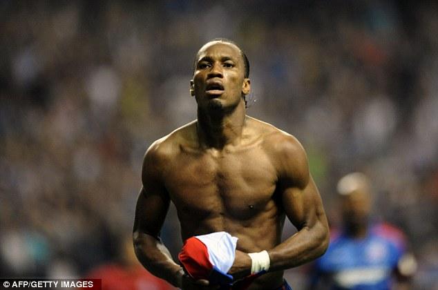 Job well done: Drogba takes his shirt off at the end of the game