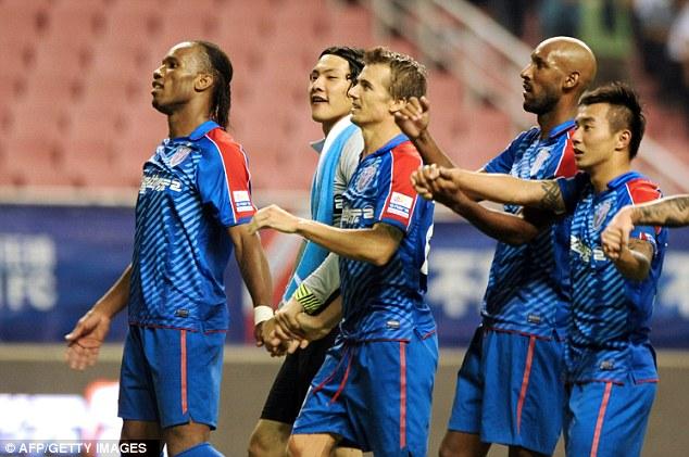 Still got it: Didier Drogba celebrates with team-mats, including Nicolas Anelka, after his goal for Shanghai Shenhua