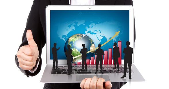 man holding computer screen with professionals shaking hands