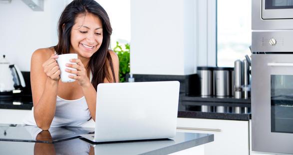 young woman having coffee in the morning with laptop