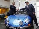 CEO of French carmaker Renault Carlos Ghosn (L) shakes hands with Malaysian chairman of British coach builder Caterham, Tony Fernandes next to a Renault Alpine A-110, after a press conference presenting Renault group's strategy, on November 5, 2012 in Paris. Renault and Caterham are to design and produce sports vehicles in Renault's plant in Dieppe, northern France, within the joint Automobiles Alpine Renault company, the groups announced on November 5, 2012. AFP PHOTO / FRANCOIS GUILLOT