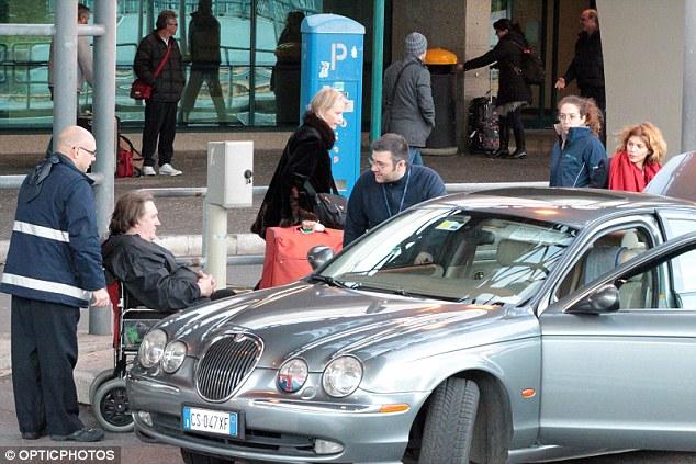 Pain: The actor appeared to be in pain as he was transported to a waiting car by wheelchair, with partner Clementine Igou 