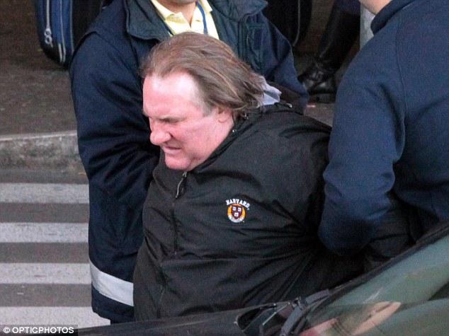 Deteriorating: Gerard doesn't look well as he tries to get himself into the waiting car