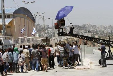 Actors play the role of Palestinian protesters during filming on the set of 