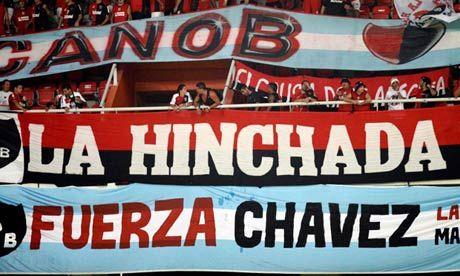 A banner reading 'Be strong Chávez' is displayed at a Venezuelan football match