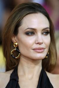 958735_actress-angelina-jolie-poses-on-arrival-at-the-18th-annual-screen-actors-guild-awards-in-los-angeles