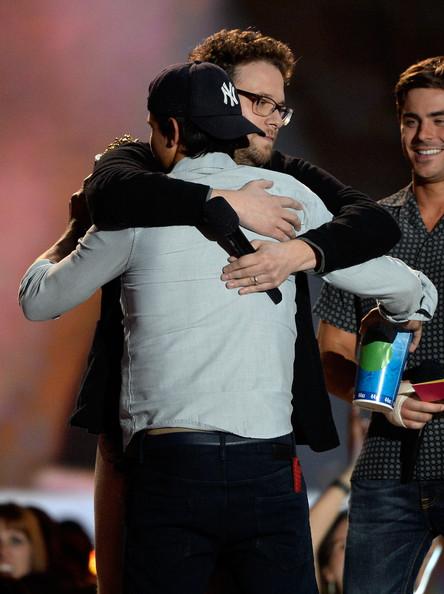 Taylor Lautner Actor Taylor Lautner (L) accepts the Best Shirtless Actor award from Seth Rogen onstage during the 2013 MTV Movie Awards at Sony Pictures Studios on April 14, 2013 in Culver City, California.