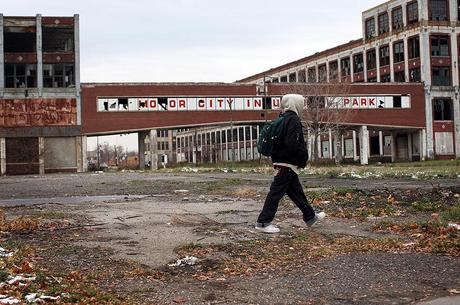 A person walks past the remains of the Packard Motor Car Company